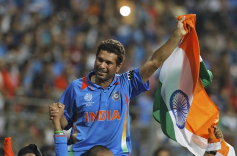 India's Tendulkar waves national flag as he is carried by his teammates after they beat Sri Lanka in the ICC Cricket World Cup final match in Mumbai