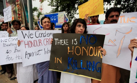 Members of civil society and the Human Rights Commission of Pakistan hold placards during a protest in Islamabad May 29, 2014 against the killing of Farzana Iqbal, 25, by family members on Tuesday in Lahore. Pakistani Prime Minister Nawaz Sharif has demanded to know why police apparently stood by while Farzana Iqbal, a pregnant woman, was stoned and beaten to death by her family in front of one of the country's top courts, his spokesman said on Thursday. She was attacked on Tuesday, police said, because she had married the man she loved. Her husband said that police did nothing during the 15 minutes the violence lasted outside Lahore High Court. REUTERS/Faisal Mahmood (PAKISTAN - Tags: CIVIL UNREST POLITICS CRIME LAW) - RTR3REE6